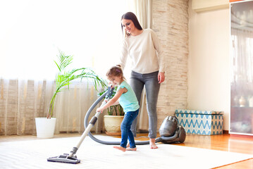 Woman and girl cleaning floor together