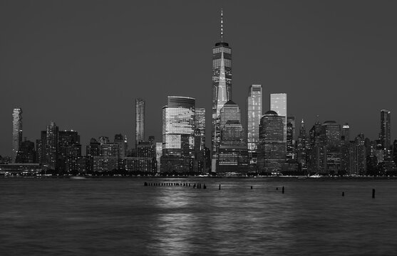 Black and white photo of Manhattan skyline at night, New York City, USA.