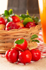 Fresh acerola fruits in a bamboo basket with in front view