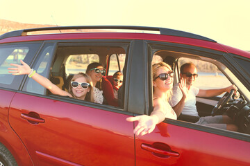 Happy smiling family with daughters in the car with sea background