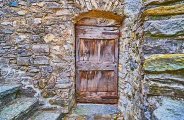 The stone wall and old wooden door, Bre, Switzerland