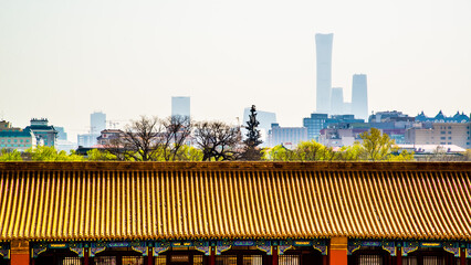 Beijing, China - April 17 2019: The modernized Beijing skyline versus traditional roof in forbidden...