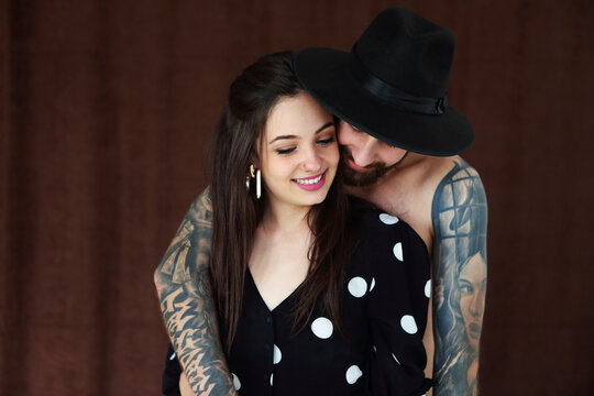 Fashion beautiful couple in hat together. Hipster boy and girl in love.
