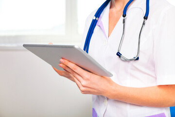 Female doctor working with tablet computer