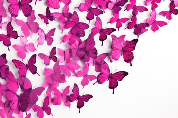  a large group of pink butterflies flying in the air on a white background with a white wall in the background.
