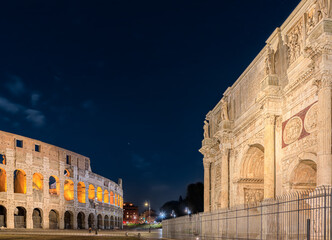 Night cityscape of Rome: view of Colosseum and Arch of Constantine, Italy.