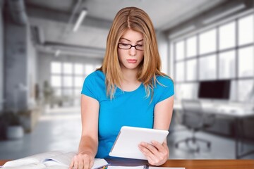 Young business woman checking bills at work in office