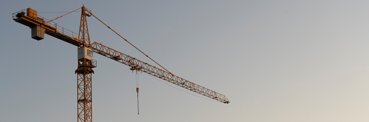 tower cranes at construction site and city background