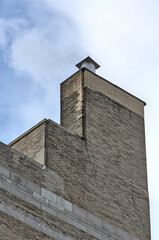 tall urban brick building chimney top detail (residential house in brooklyn new york) exhaust,...