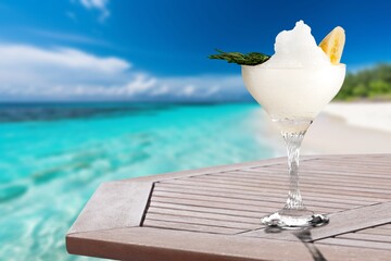 Tasty fresh alcohol cocktail on the table at the beach