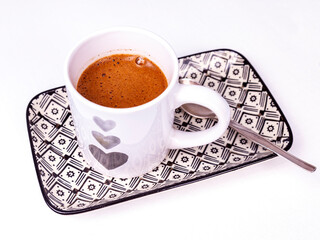 White cup with black coffee on a rectangular plate on the table - 715904957