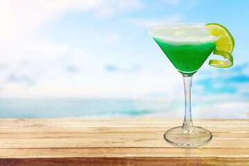 Tasty fresh alcohol cocktail on the table at the beach
