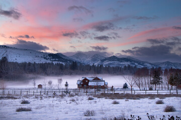 Old Wooden Farm House in the Mist at the Edge of an Evergreen Forest at Dusk - Methow Valley,...