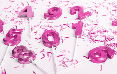 Numbers, years, birthday candles of pink color