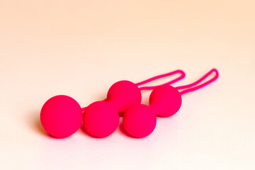 Pink Kegel balls Ben Wa balls on the table. Vaginal balls. Sex toys Geisha balls. Sex shop concept