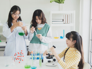 Portrait child kid girl asian young student tree people team group learning and smile have fun happy excited with science lab technology with in classroom has tubetest Microscope chemicals on table