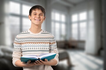 Young happy man read book at home