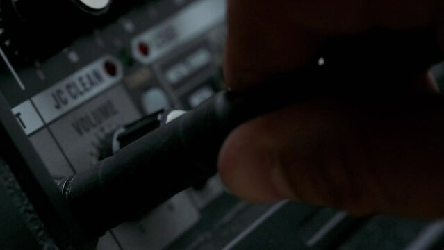 Man adjusting knobs on guitar amplifier. 4k video footage UHD 3840x2160