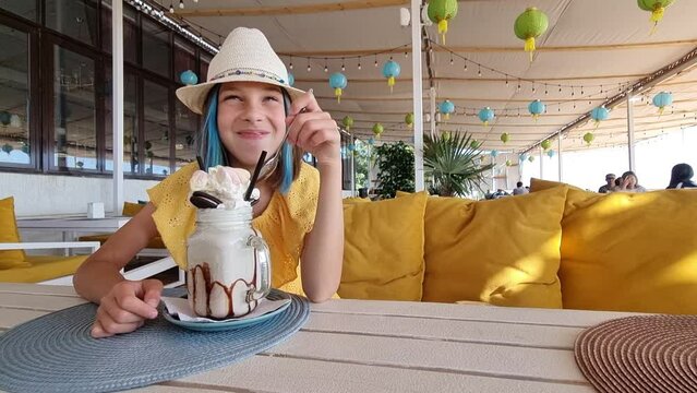 The ukrainian girl eating sweet dessert and laughing. 4k video footage in slow motion