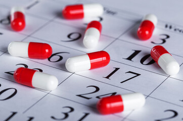Medical pills on the background of the calendar. Medicines concept.
