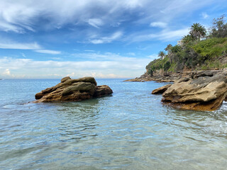 Beach landscape on the coast of an island. Rocks on the beach. Stone in turquoise water. View of...