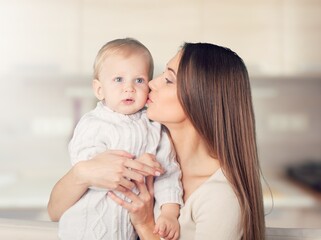 portrait of beautiful mother kissing her child