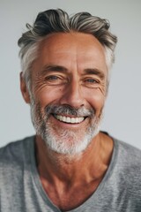 Closeup photo portrait of a handsome old mature man smiling with clean teeth