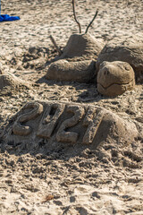a turtle sandcastle on the beach in hawaii 