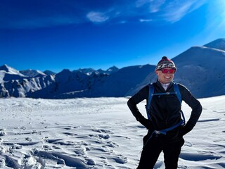 Fototapeta na wymiar Joyful mountaineer in the snow-covered Polish Tatras, basking under the winter sun
