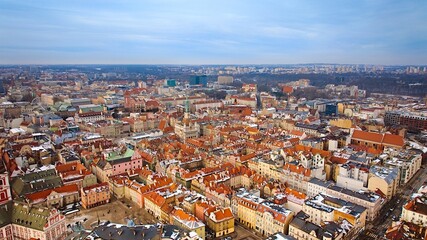 Aerial view of Poznan's historic market square in winter, showcasing the charming old townhouses...