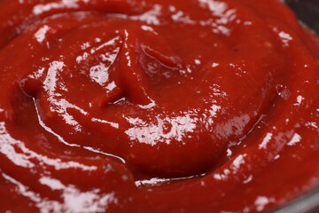 Organic ketchup as background, closeup. Tomato sauce