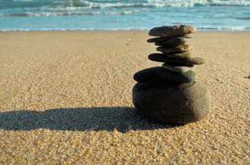 Zen rocks on the beach sand. Healthy and balanced lifestyle