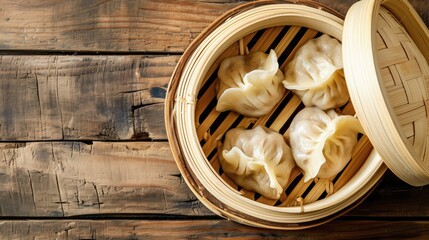 Momo dumplings in a bamboo steamer. Wooden background. Top view
