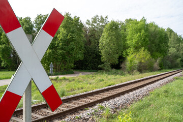 St. andrew cross with railroad tracks in the landscape