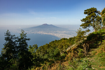 The view of Vesuvius volcano, shoreline of the Gulf of Naples and the Naples city in the fog from mount Faito shot from high angle