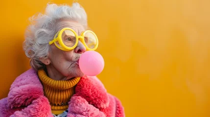 Foto op Plexiglas An old woman blowing a bubble with yellow glasses © Maria Starus