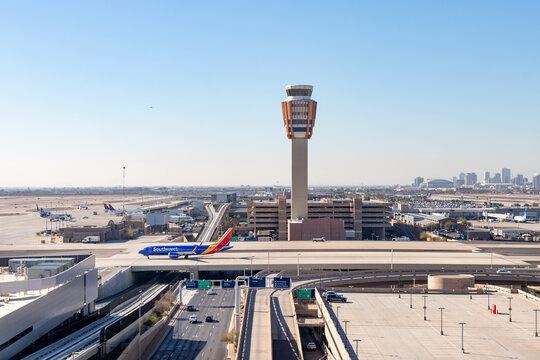 Aerial view of a Southwest Airlines Boeing 737 on taxiway bridge and air traffic control tower at Phoenix Sky Harbor International Airport - Phoenix, Arizona, USA	