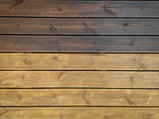 Partially painted and partly cleaned fluted wood terrace impregnated with oil. Top view of decking of wooden planks