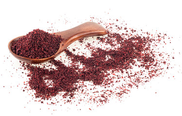Ground sumac spice in wooden spoon isolated on a white background