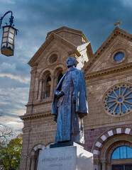 SANTA FE, NEW MEXICO,  USA - NOV 13, 2015: A bronze statue of the first Archbishop of Santa Fe, New Mexico, Archbishop Jean Baptiste Lamy in front of the Cathedral Basilica of St. Francis. © Alex Ragen