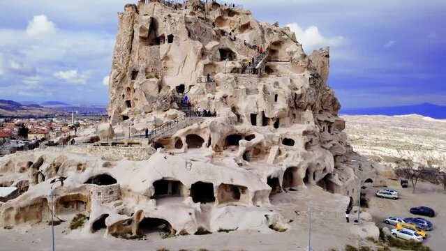 Drone reveals Uchisar Castle's geological splendor in Cappadocia. Stunning geological formations frame Uchisar, highlighting geological wonders of Cappadocia