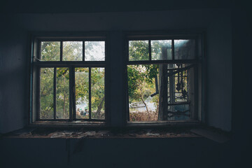 an abandoned broken windows. Old destroyed houses. Broken glass in the window. War, destruction,...