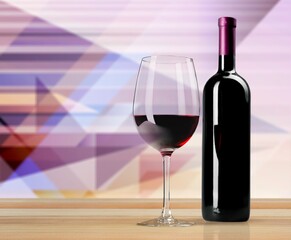 Bottle and glass of tasty alcohol red wine