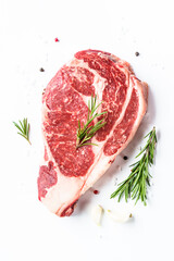 Beef steak with spices. Ribeye steak raw marble meat on white.