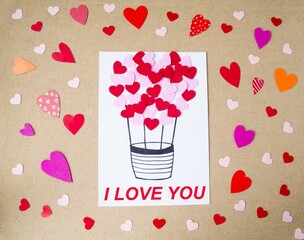 Handmade holiday card for Valentine's Day, love theme.  Beautiful balloon in the shape of a heart.  Flat lay, top view.  Valentine's Day holiday concept.