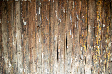 A wooden fence stained with paint from a paintball game.