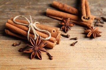 Different aromatic spices on wooden table, closeup