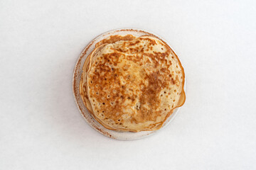 Homemade pancake seen from above on a white background