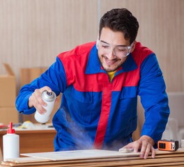 Yooung repairman carpenter working with paint painting