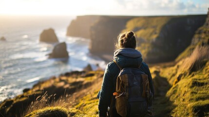 Person stood on a cliff overlooking the sea